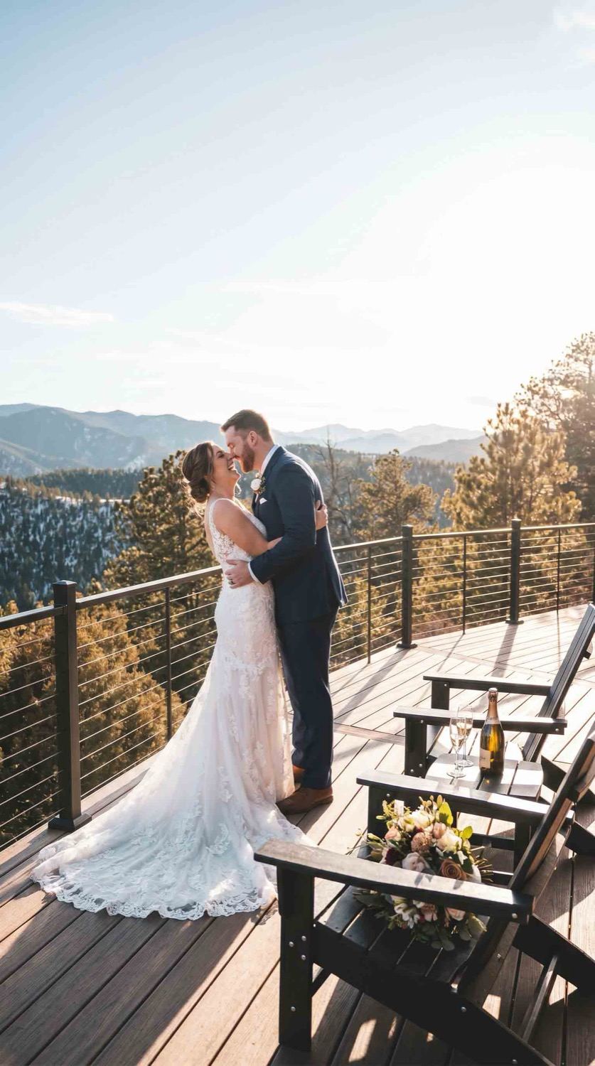A couple at golden hour on the deck with the range behind them